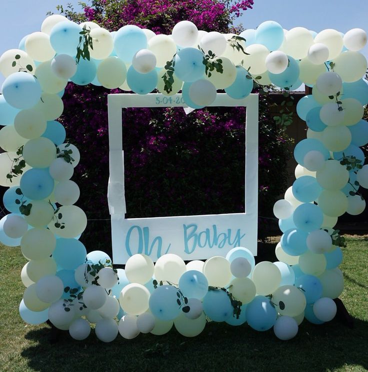 a blue and white balloon arch for a baby's first birthday