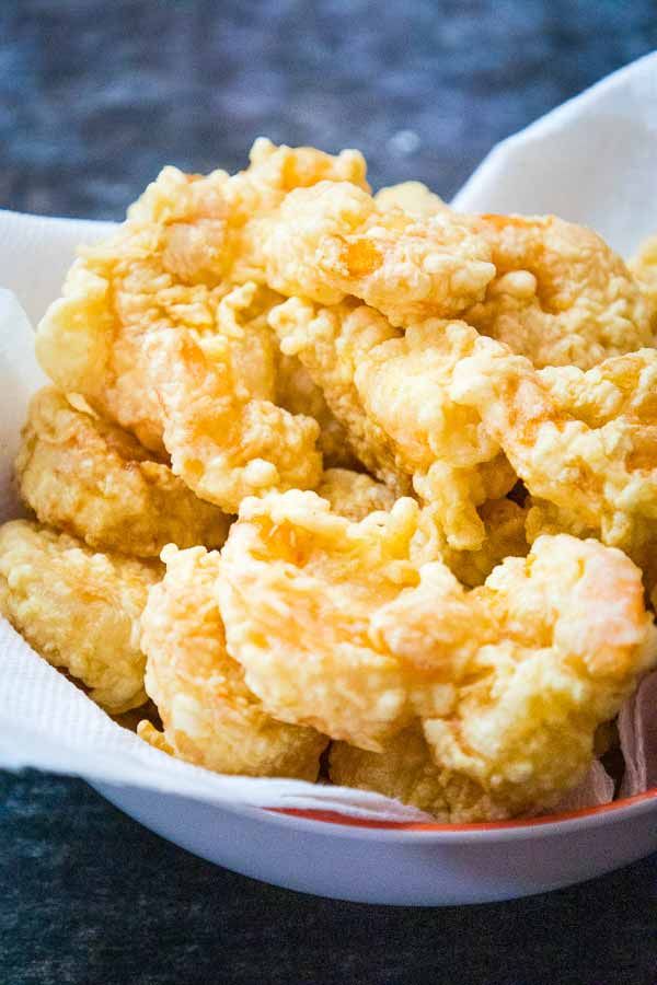 a bowl filled with fried food on top of a table