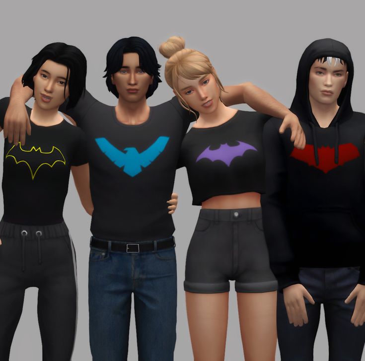 three females are standing next to each other with their arms around one another, both wearing batman shirts