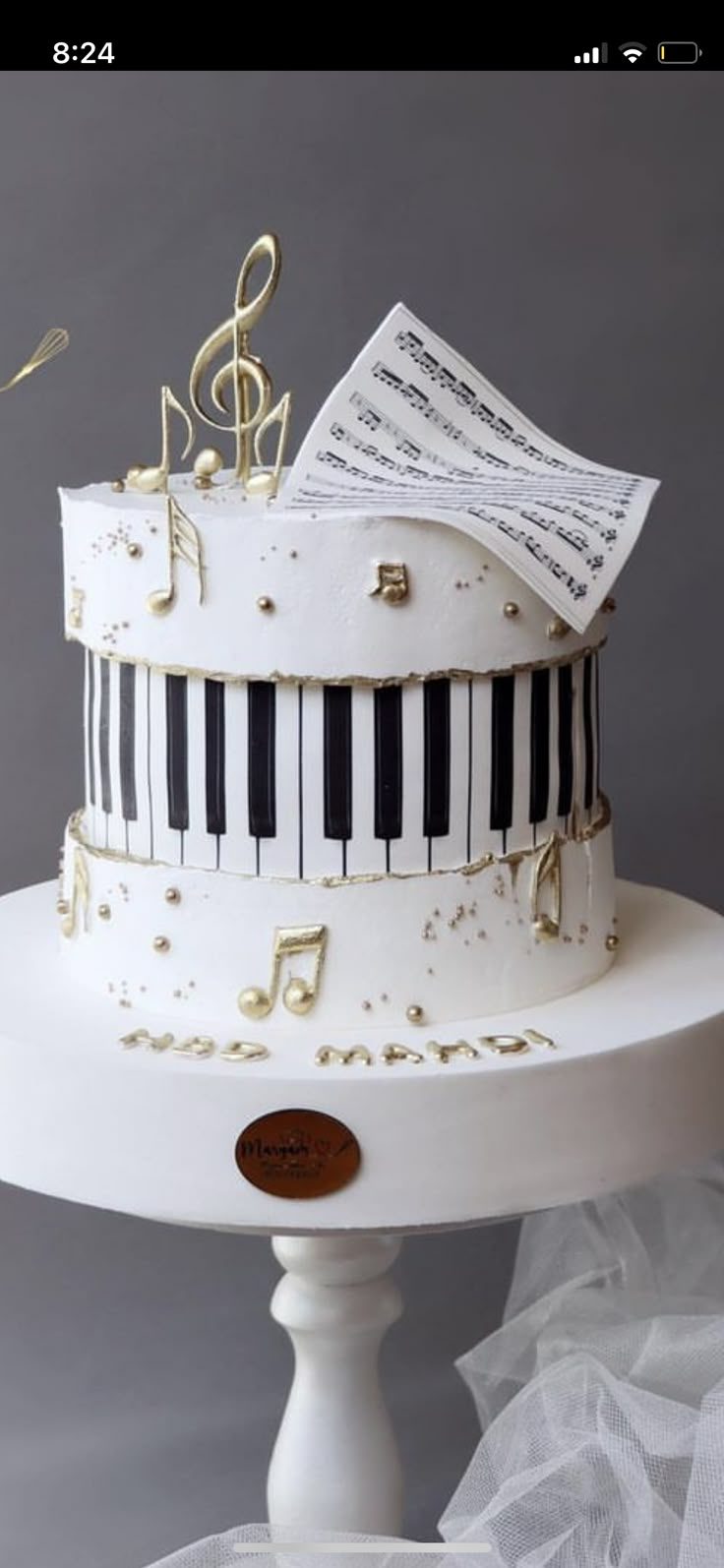 a wedding cake decorated with musical notes and piano keys