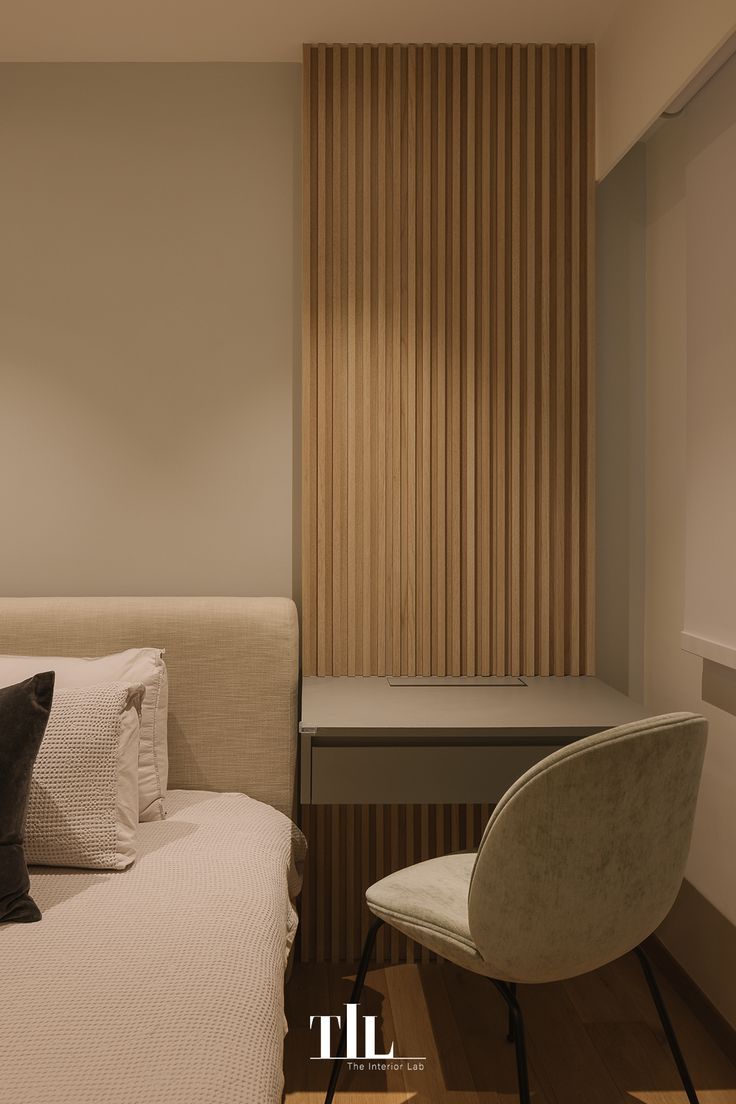 a white bed sitting next to a window with wooden slats on the wall behind it