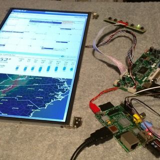 electronic components are displayed on the floor next to a computer screen and circuit board with wires