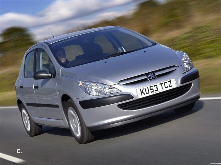 a silver car is driving down the road