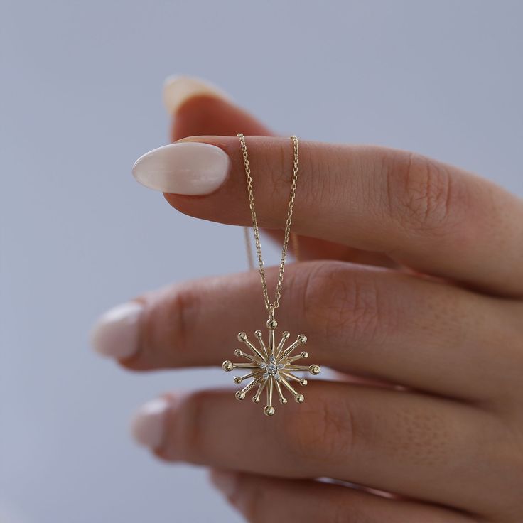 Diamond & 14K Solid Gold Starburst Necklace: This stunning 14K solid gold starburst pendant with your choice of genuine diamond or cubic zirconium stone is a symbol of guidance, protection, inspiration and hope. Bold enough to make a statement on its own, and minimal enough to be layered with other pieces, this necklace will glow brightly and help serve as a reminder that there is meaning and purpose behind every destination.  Materials & Specifications:  - 14K solid gold chain and pendant - Genuine diamond or cubic zirconium stone  - Chain thickness is 2.5mm - Pendant dimensions are 1.6cm x 1.6cm Available in 5 different chain lengths: 42cm (16.5 in), 45cm (17.7 in), 47cm (18.5 in), 49cm (19.3 in) As with all of our products, this item is handmade and made to order. **WEARING YOUR JEWELRY 3 Diamond Pendant, 14k Gold Starburst Jewelry Gift, 14k Gold Starburst Jewelry As Gift, 14k Gold Starburst Jewelry For Gift, Yellow Gold Starburst Necklace As Gift, Starburst Fine Jewelry Necklace As Gift, Yellow Gold Starburst Necklace For Gift, Starburst Fine Jewelry Necklace For Gift, Dainty Starburst Yellow Gold Jewelry