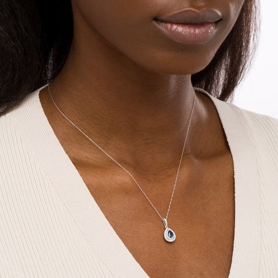 Increase the elegance factor of your dressy looks with this beautiful gemstone and diamond pendant. Fashioned in 14K white gold, this choice showcases a 6.0 x 4.0mm pear-shaped bright blue sapphire wrapped in a double frame of shimmering diamonds. Additional diamonds glisten along the linear bail to complete the design. Captivating with 3/8 ct. t.w. of diamonds and a brilliant buffed luster, this pendant suspends along an 18.0-inch rope chain that secures with a spring-ring clasp. Diamond Drop Jewelry With Polished Finish, Elegant Sapphire Diamond Necklace For Formal Occasions, Elegant Drop Diamond Necklace With Gemstone, Formal Teardrop Diamond Necklace With Gemstone, Formal Teardrop Gemstone Diamond Necklace, Elegant Sapphire Diamond Necklace, Elegant Birthstone Necklace With Diamond Accents, Elegant Sapphire Drop Jewelry, Elegant Blue Diamond Pendant Necklace