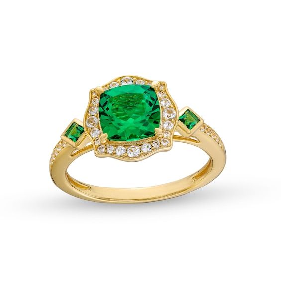 Achieve a most charming look with this lab-created emerald and diamond floral frame ring. Sterling silver with 14K gold plate. The 7.0mm cushion-cut lab-created emerald is surrounded by a floral frame of multi-sized diamonds. Tilted bezel-set Asscher-cut lab-created emeralds flank the centerpiece. Diamond-lined shank completes the design. 1/5 ct. t.w. of diamonds. Elegant Emerald Cluster Ring With Brilliant Cut, Elegant Cluster Ring With Emerald For May Birthstone, Elegant Emerald Cluster Ring With Gemstones, Elegant Emerald Cluster Ring With Center Stone, Elegant Emerald Cluster Ring For May Birthstone, Elegant Green Cubic Zirconia Birthstone Ring, Elegant Jewelry With Center Stone For May Birthstone, Elegant May Birthstone Jewelry With Center Stone, Elegant Emerald Halo Ring In Yellow Gold