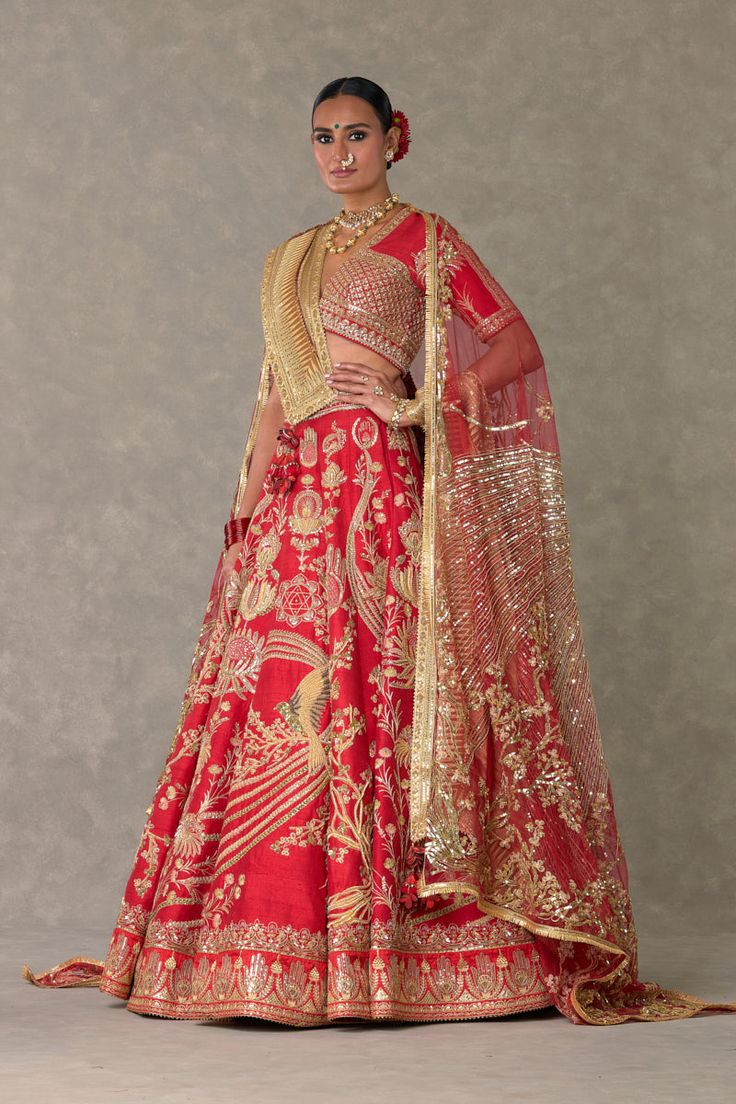 Embrace timeless beauty in this lehenga set adorned with a medley of motifs—son-chidiya, haath-phool, neel-kamal, and shajara—in dori, multi-colored thread, sitara, and moti kaam. The hemline features an embroidered haathphool border and kinari edging, accompanied by a practical pocket detail. The can can skirt blouse, with dori, multi-colored thread, sitara, and moti kaam, boasts a 'V' neckline and elbow sleeve The printed lining brocade dupatta, woven with our signature 'haath-phool' border an Haath Phool, Maroon Lehenga, Lehenga And Blouse, Caribbean Fashion, Sari Skirt, Raw Silk Lehenga, Full Sleeve Blouse, Bridal Lehenga Red, Red Lehenga