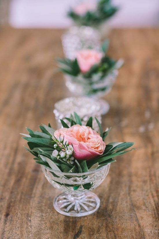 three small glass vases with flowers in them