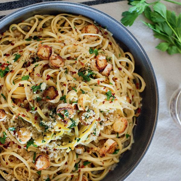 a bowl filled with pasta and shrimp on top of a table