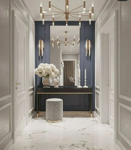 a hallway with marble floors and blue walls