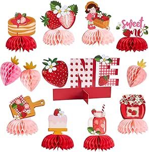 paper strawberries and other decorations are arranged in the shape of the word love