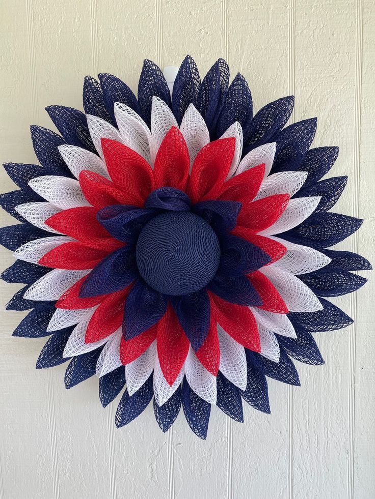 a red, white and blue wreath hanging on the wall