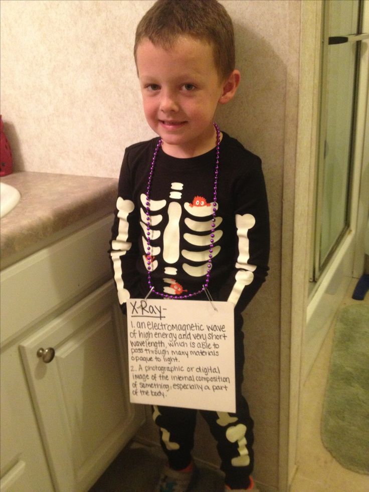 a young boy standing in front of a bathroom sink wearing a skeleton shirt and leggings