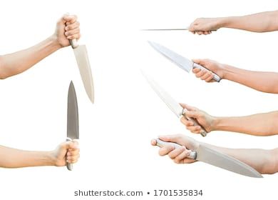 the hands are holding two large knives in each hand and one is holding another knife