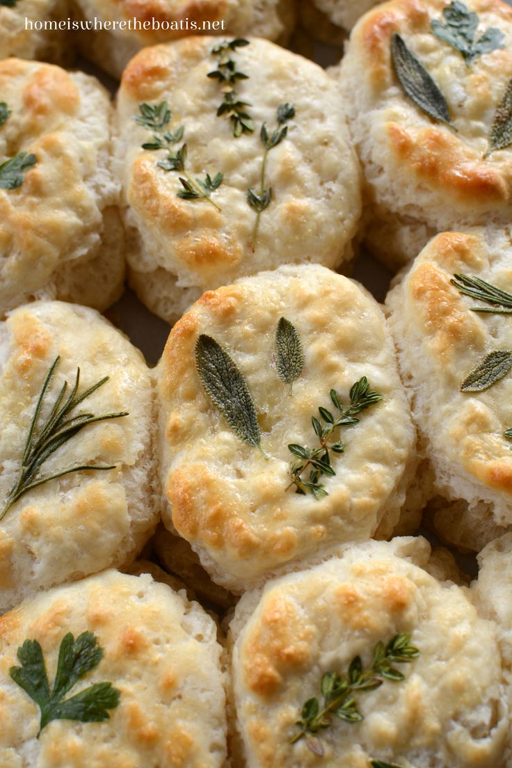 several biscuits with herbs on them are shown