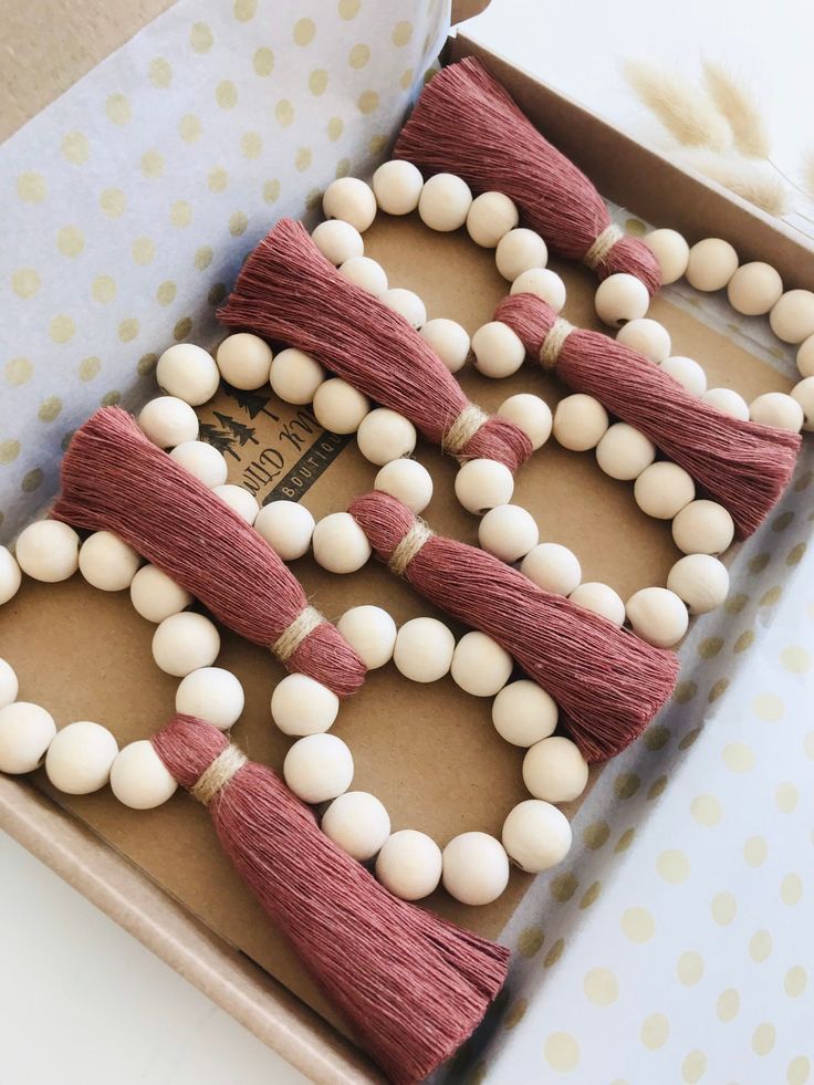 a box filled with beads and tassels on top of a table