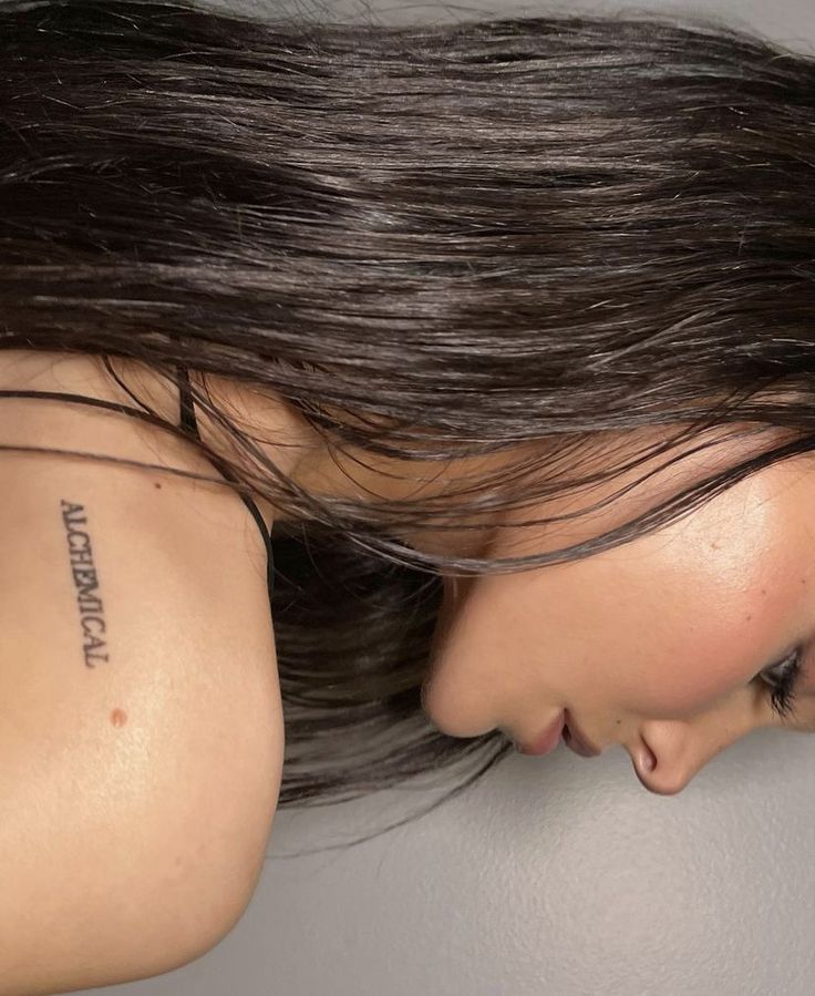 a woman with a tattoo on her shoulder