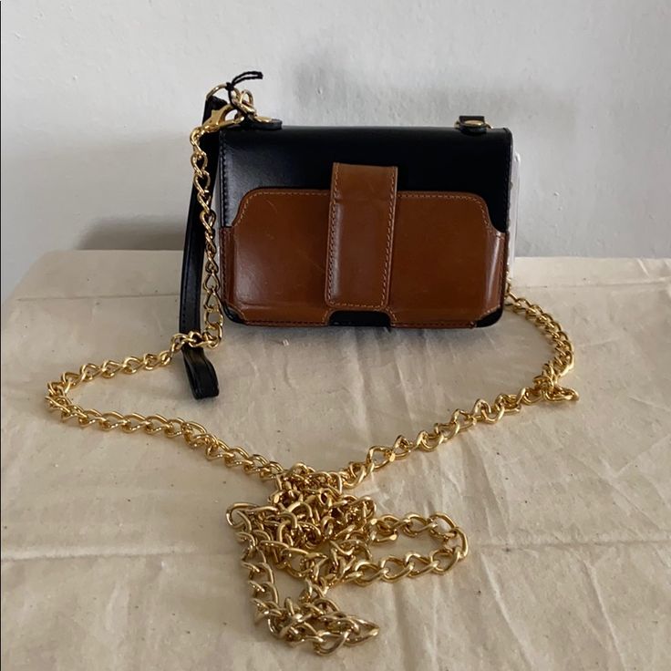 Nwt Case-Mate Leather Gold Chain Bag Or Wristlet I Had This For A Couple Of Years And Never Used It. It’s A Small Wallet W/ A Detachable Gold Chain. Has A Snap Closure On The Outside That Was Made For A Smaller Phone. The Inside Has An Id Slip Pocket W/ 2 Credit Card Pockets. A Snap Coin Pocket As Well As 2 Slip Pockets Inside. Also, 1 Slip Pocket On The Outside. It Can Also Be Used As A Wristlet. Zipper Opening. Comes With Dust Bag. Approximate Measurements 3.5 X 5.2” Chain Drop 26” Brown Rectangular Clutch With Mobile Phone Holder, Brown Rectangular Clutch With Mobile Phone Bag, Black Square Wallet For Everyday Use, Black Square Wallets For Everyday Use, Everyday Rectangular Wallet On Chain With Detachable Strap, Everyday Wallet On Chain With Detachable Strap, Evening Bags With Metal Hardware In Brown, Chic Brown Box Bag With Chain Strap, Brown Evening Bags With Metal Hardware