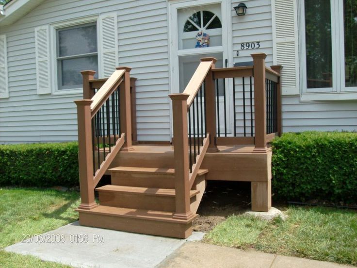 a set of stairs leading up to a front door on a home's porch