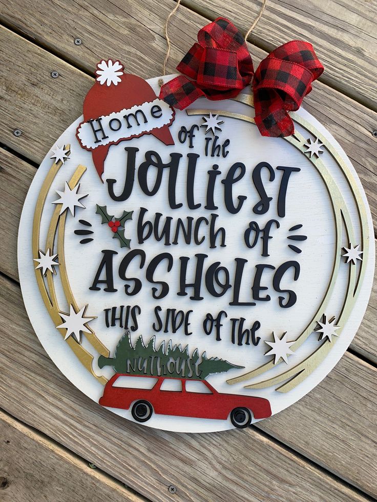 a christmas ornament that says home is the jolliest bunch of acholies this side of the house