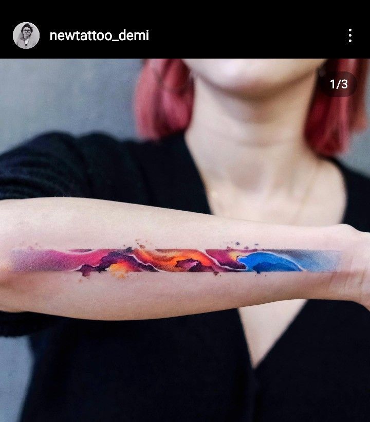 a woman's arm with a colorful tattoo on it