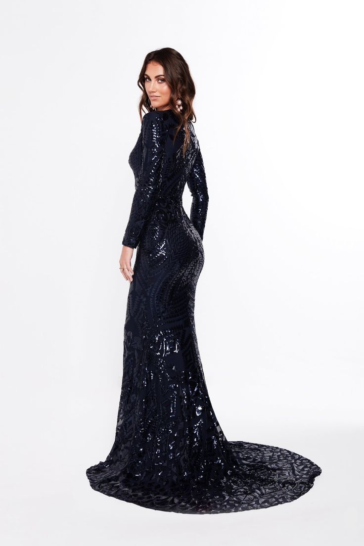 The Julieta is an elegant long sleeve sequins gown. It is made with beautiful geometric fabric and has a lot of stretch to it. The features on this gown are an elegant v neckline, long sleeve and a small mermaid train. The material is quite stretchy and there is an exposed back zipper. What is a Made-To-Order? This product is a made-to-order item. Made-to-order items are not held in physical stock and production commences AFTER order placement. We try to limit production and stock levels and as Gala Maxi Gown With Contrast Sequin, Long Sleeve Evening Dress For Fall Gala, Formal Long Sleeve Gown For Gala, Fall Long Sleeve Evening Dress For Gala, Fall Long Sleeve Gala Evening Dress, Elegant Long Sleeve Gown With Contrast Sequin, Formal Gown With Contrast Sequin And Long Sleeves, Embellished Long Sleeve Gown, Embellished Long Sleeve Maxi Dress For Gala