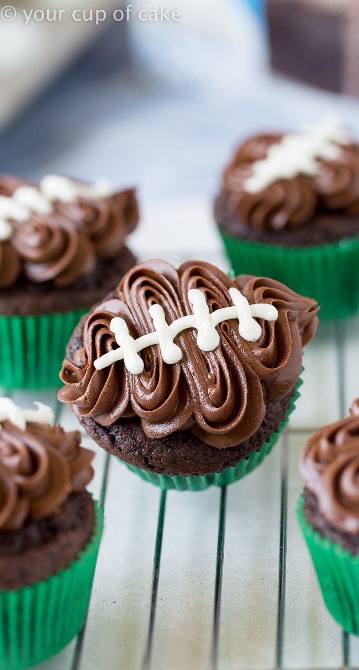 chocolate cupcakes with frosting and football decorations