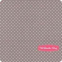 a gray and white polka dot print placemat