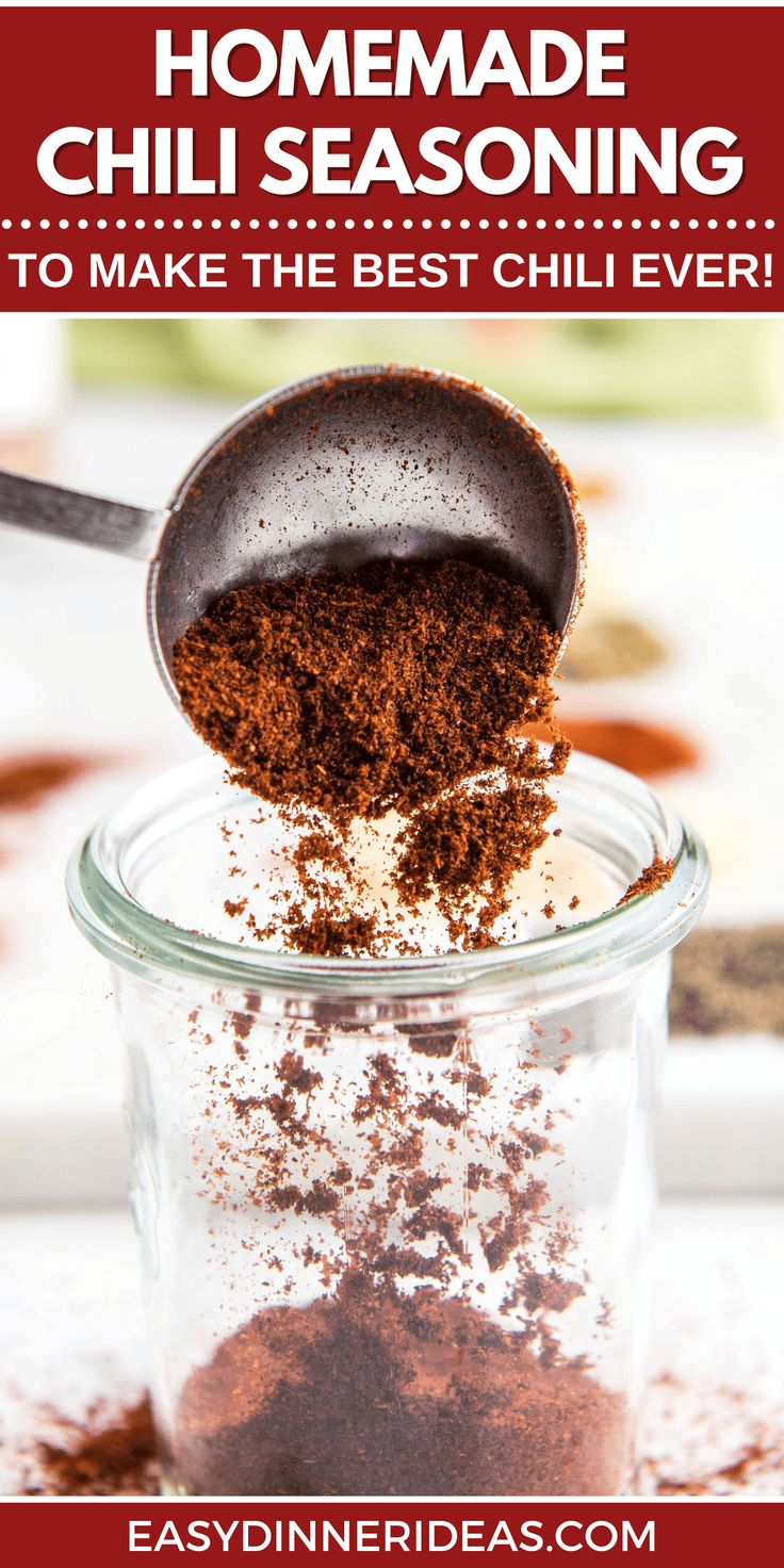 homemade chili seasoning in a glass jar with a spoon scooping out the top