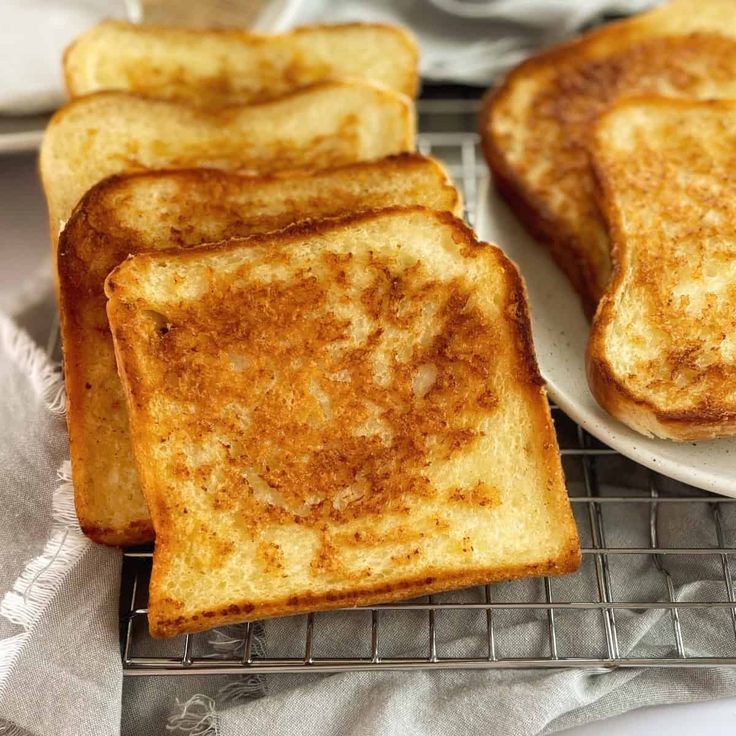 four slices of grilled cheese on a plate