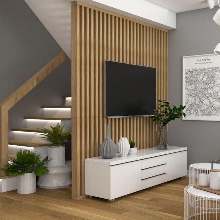 a modern living room with white furniture and wood paneling on the walls, along with a flat screen tv