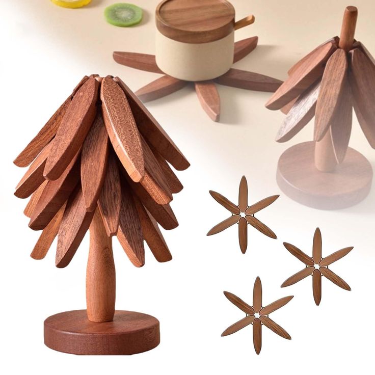 a wooden christmas tree and other decorations on a white surface with some cut out wood pieces