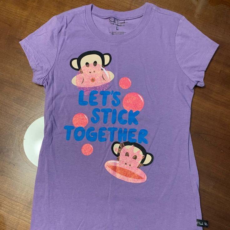 Never Worn Paul Frank Purple T Shirt Happy Bunny Shirt, Casual Purple T-shirt With Cartoon Print, Playful Purple Summer T-shirt, Playful Relaxed Fit Shirt With Graphic Print, Cute Purple Short Sleeve T-shirt, Purple Crew Neck Top With Cartoon Print, Casual Purple Screen Print Shirt, Fun Purple Crew Neck Top, Purple Cotton Tops With Cartoon Print