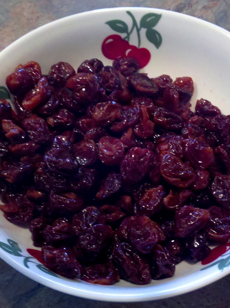 a white bowl filled with raisins on top of a table