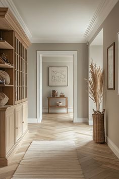 an empty hallway with wooden shelves and vases on the wall, along with other items