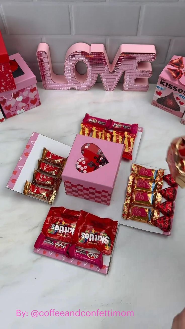 valentine's day candy boxes and love letters on a table