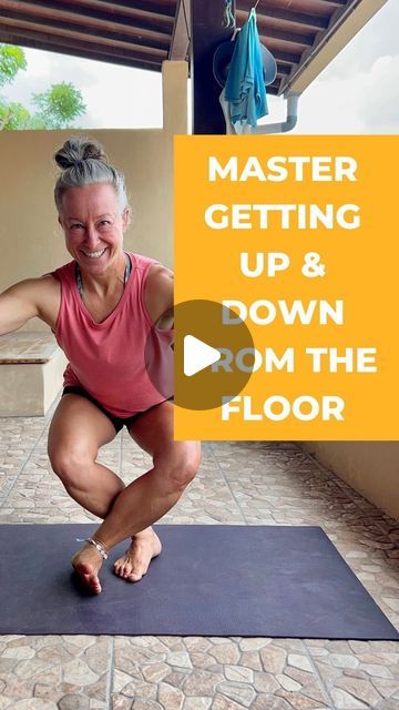 a woman in pink shirt doing yoga on blue mat with text overlay reading master getting up & down from the floor