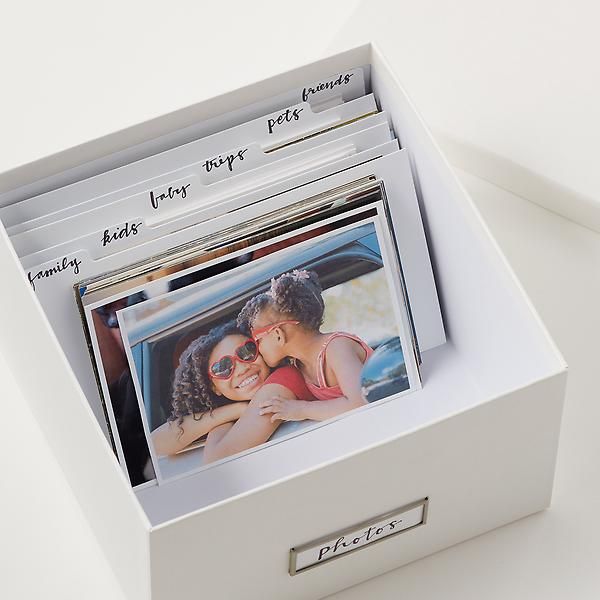 an open box with photos inside sitting on a table