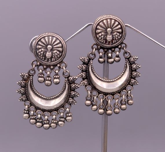 Vintage antique design handmade pretty earrings tribal Earrings stud,wedding jewelry,tribal jewelry,drop dangle stud,bird earring belly dance jewelry,attractive lovely earrings light weight jewelry with gorgeous hanging bells earrings from Rajasthan India.Metal-925 Sterling silver.Item - EarringStyle - StudEarring Weight -25.880  GramsEarring Length-5.3 CentimeterEarring Width -3.5 cmStamped - 925Finish - OxidizedMakes excellent gifting and collectible pieces. Traditional Silver Dangle Clip-on Earrings, Traditional Metal Dangle Clip-on Earrings, Silver Round Clip-on Earrings For Festive Occasions, Ornate Silver Bridal Earrings With Latkans, Ornate Chandbali Sterling Silver Earrings, Silver Traditional Pierced Bridal Earrings, Traditional Silver Metal Clip-on Earrings, Traditional Silver Round Chandelier Earrings, Crescent Oxidized Sterling Silver Earrings