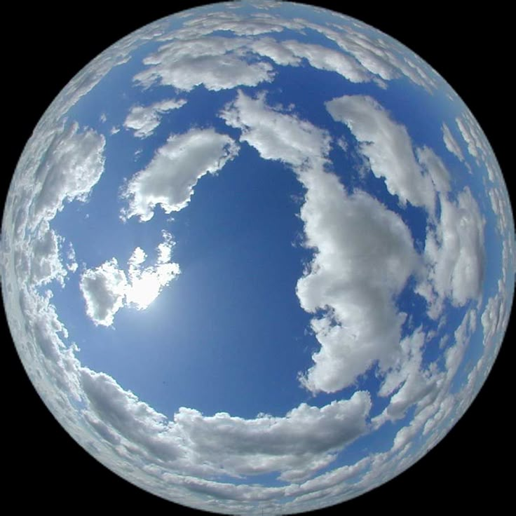 an image of the sky and clouds in a glass ball ornament on a white background