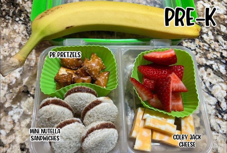 a plastic container filled with different types of food next to a banana and other foods