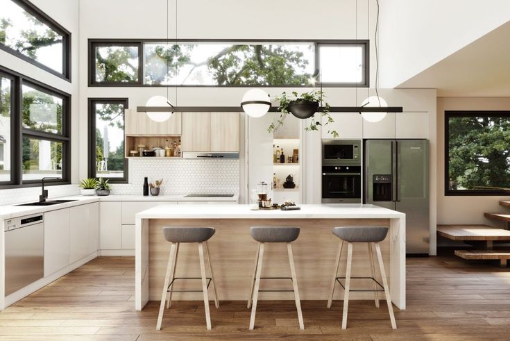 an open kitchen with three stools next to the counter top and island in front of it