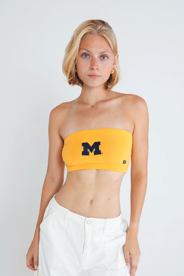 Our all time classic bandeau top is a staple for game days. Made with soft cotton-spandex with an elastic hem. DETAILS 95% Cotton, 5% Spandex Screenprint or embroidered logo application P.S. We’d love to see you repping this style! Make sure to tag us (@hypeandvice) to be featured :) Fitted Athleisure Tops For College, Trendy Stretch Cotton Tube Top, Seamless Cotton Bandeau Tube Top, Cotton Seamless Bandeau Tube Top, Basic Cotton Sports Crop Top, Trendy Seamless Cotton Tube Top, Basic Cotton Crop Top For Sports, Sporty Stretch Tops For Cheerleading, Stretch Sporty Tops For Cheerleading