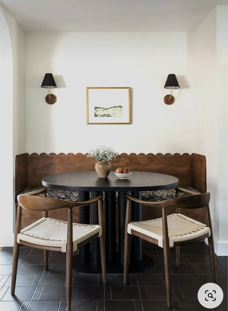 a dining room table with two chairs around it