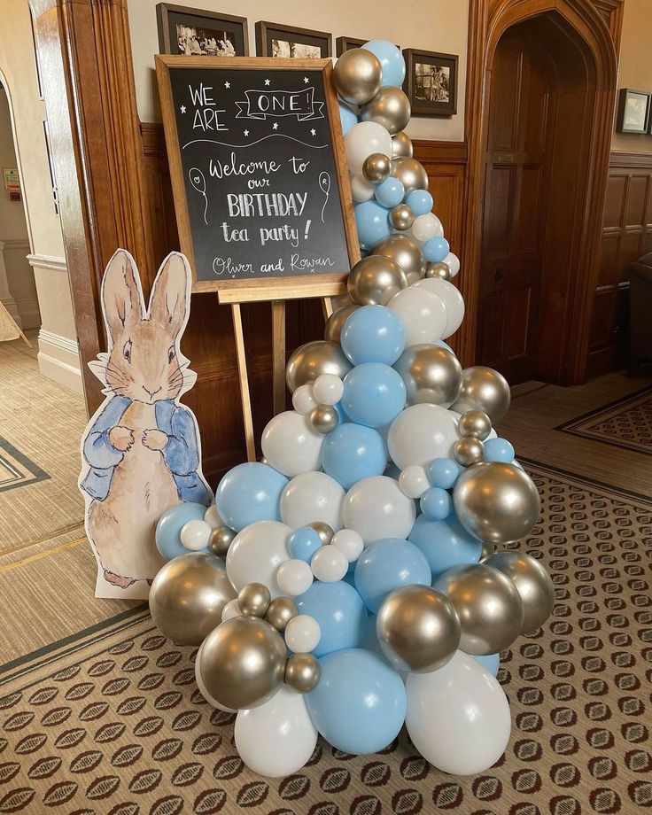 a birthday cake made out of balloons in the shape of a tree with a bunny on it