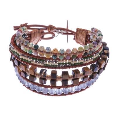 This eye-catching wristband bracelet from Siriporn in Thailand features 4 brown leather strands each knotted with different beads. One strand features a double row of agate beads in a rainbow of colors; the next is strung with tiny glass beads in green cream and copper. The third strand is studded with cubes of tawny tiger's eye while the fourth strand is populated with gray quartz beads. The bracelet can be fastened at one of two lengths with a 950 silver toggle. Adjustable Hand Wrapped Leather Bracelet With Round Beads, Adjustable Hand-wrapped Beaded Leather Bracelet, Bohemian Adjustable Hand Wrapped Leather Bracelet, Adjustable Beaded Leather Bracelet - Spiritual Style, Adjustable Brown Bracelets As Fashion Accessory, Adjustable Brown Bohemian Beaded Bracelets, Adjustable Hand-strung Leather Bracelet, Bohemian Brown Bracelets As Fashion Accessory, Bohemian Brown Leather Bracelet Hand Wrapped