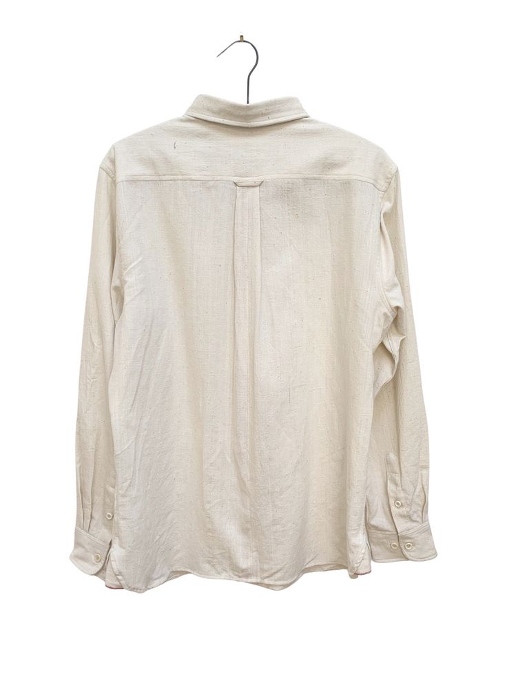 a white shirt hanging on a hanger