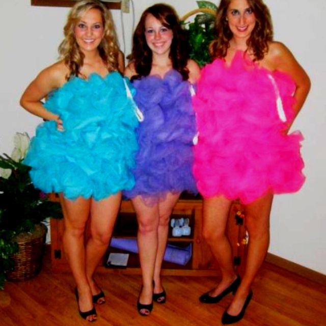 three women in dresses standing next to each other