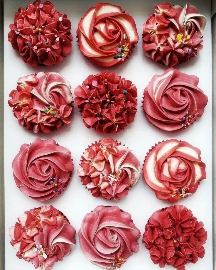 a box filled with lots of red flowers on top of each other in different shapes and sizes