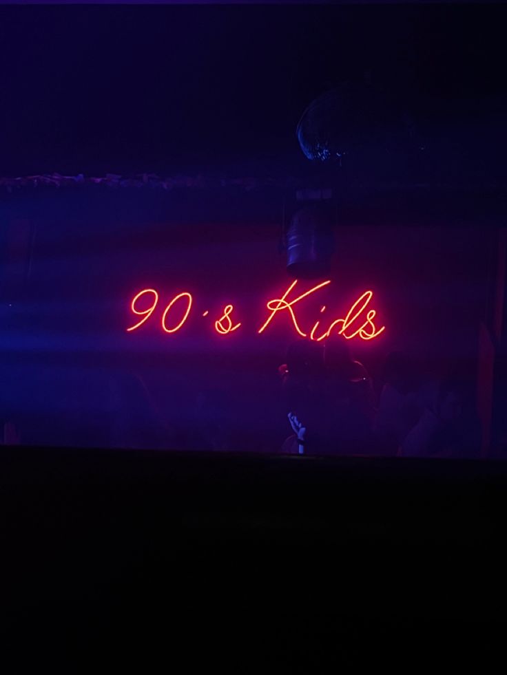 a neon sign that reads 90 and kids